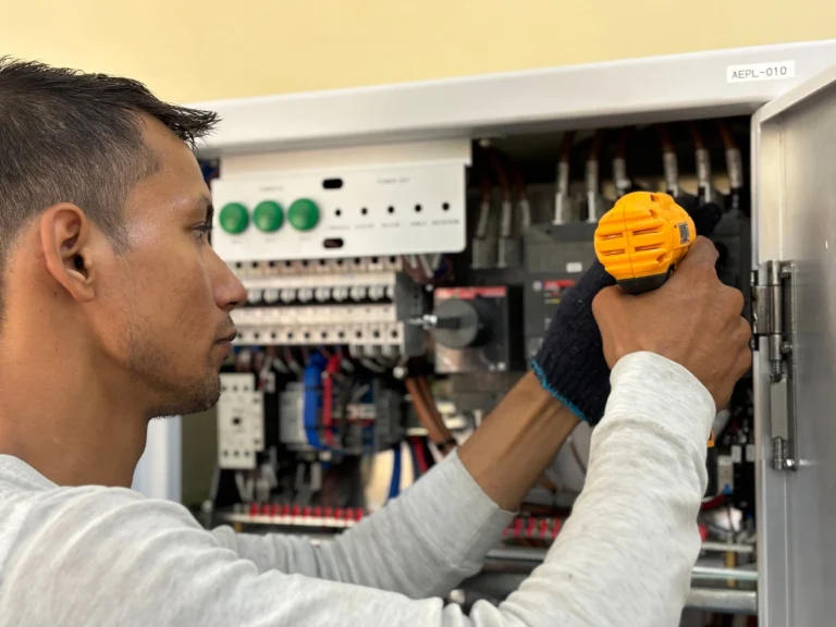 Commercial electrician working on an electrical panel in Oceanside, CA